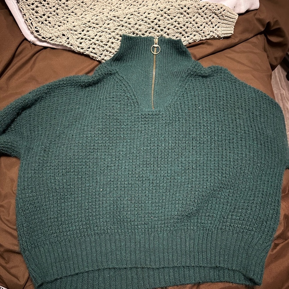 dark green sweater with gold quarter zip